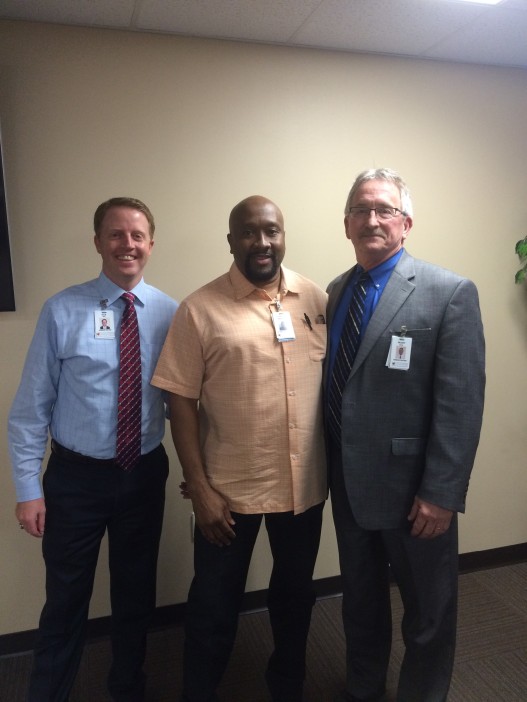 Kyle Swift, CEO of Woodland Heights (left) and Buddy Whiddon, CFO of Woodland Heights (right) award Kalvin Buckley, Director of Information Systems, the Non-Clinical Director of the Year Award for 2015. Photo: Woodland Heights Medical Center.)