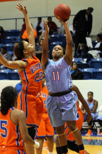 Angelina College’s Ariel Taylor (11) drives for a layup over McLennan’s Diamond Ervin (22) during Saturday’s game at Shands Gymnasium. The Lady Roadrunners used a third-quarter surge to take down the Highlassies 72-65 in the final day of the Angelina Classic. (Photo: DeShun Pham-Adams | AC Press photo)