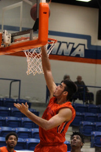 Angelina College’s Shane Temara puts back a miss against Pro-Vision Academy Academy during Wednesday’s scrimmage at Shands Gymnasium. The Roadrunners raced to a 109-97 win in the team’s final pre-season game before opening the regular season on Saturday. (Photo by: AC News Service)