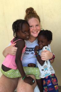 Missionary Kassidy Eberlan, center, takes a photo with Haitians Annanee, left, and Dashca. 