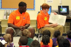 Angelina College basketball player Josiah Garges (right) and manager Xontavier Williams read to Trout Elementary students. The Roadrunner basketball program tipped off its “Roadrunner Read-a-Thon” on Friday, a program in which the coaches and players will visit and read to area elementary schools. (AC Athletics photo/Gary Stallard)